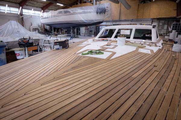 Teak is mounted by hand on the Nordship 570 DS deck